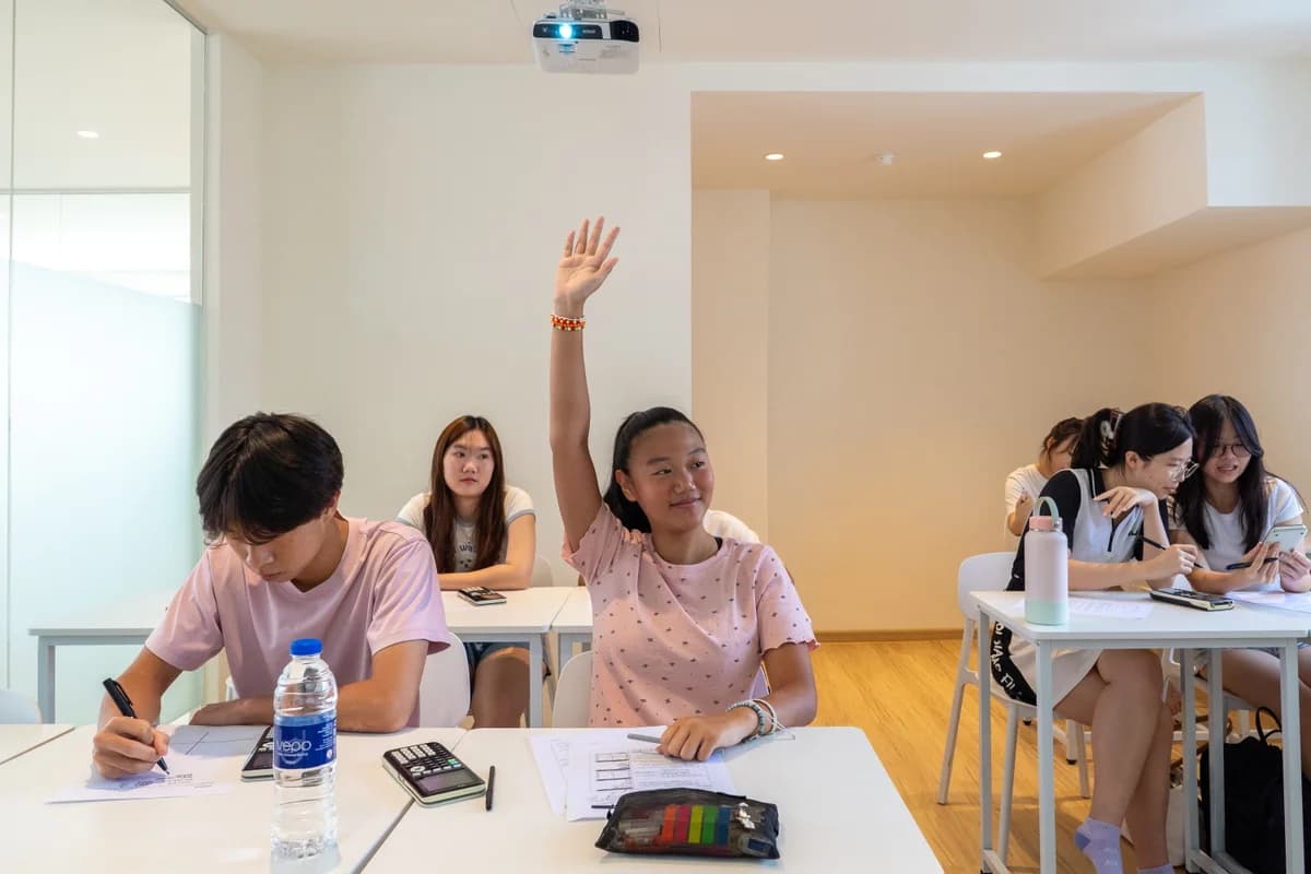 Student raising her hand in a Knockout Math classroom